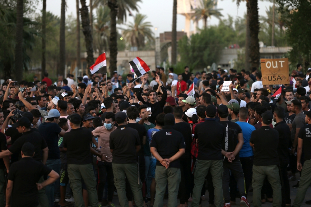 Iraqi security forces stand guard during a protest at Tahrir square in Baghdad, Iraq July 27, 2018. REUTERS/Thaier al-Sudani