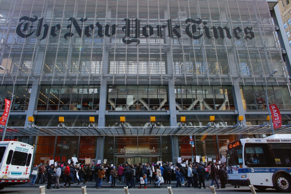 In this file photo taken on February 26, 2017 People take part in a protest outside the New York Times in New York.  AFP / Kena Betancur

