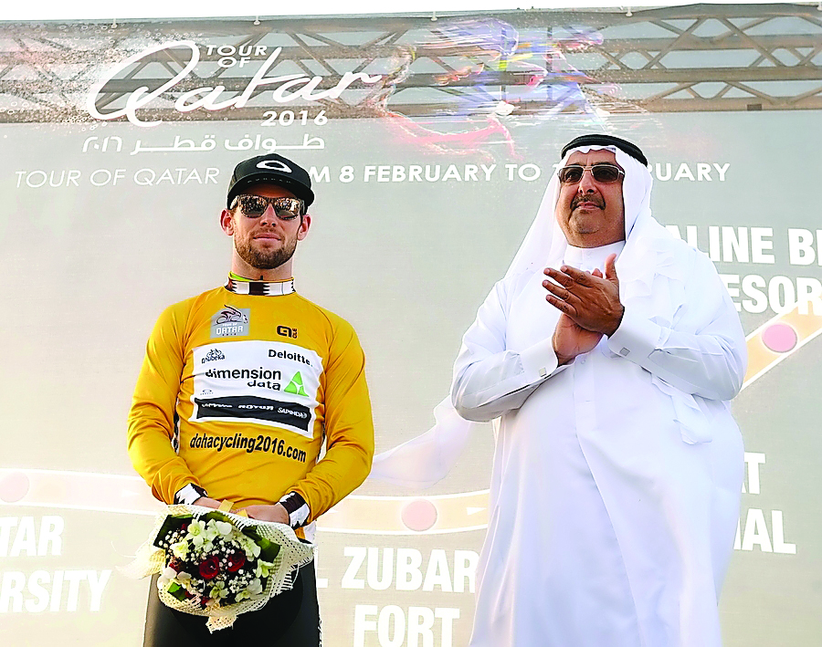 FILE PHOTO: British rider Mark Cavendish (L) of the Dimension Data team celebrates on the podium wearing the overall leader's golden jersey next to Sheikh Khalid Bin Ali Al Thani (R), President of the Qatar Cycling Federation (QCF), after winning the firs