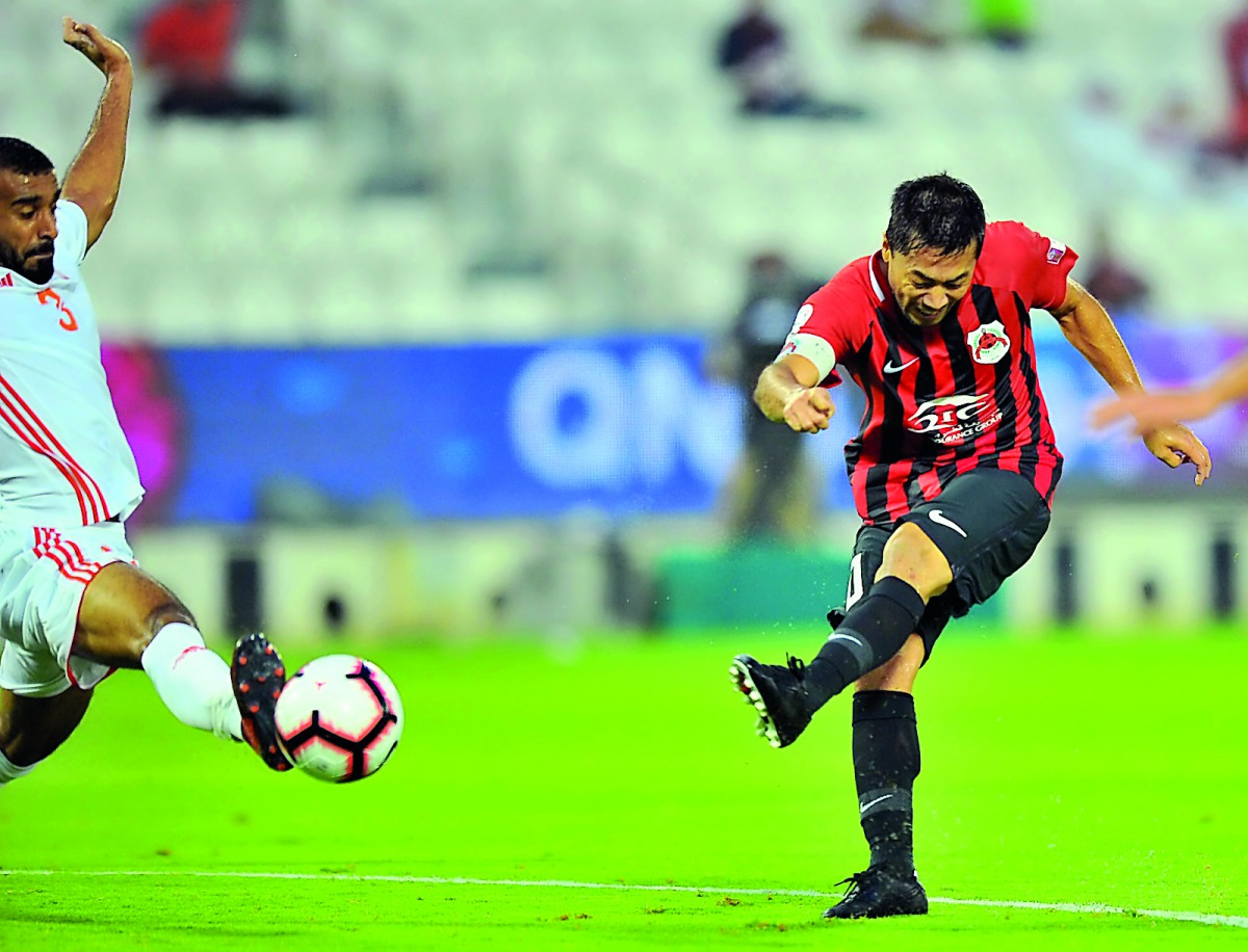 Al Rayyan skipper Rodrigo (right) shoots at goal during their QNB Stars League match against Umm Salal at the Al Sadd Stadium yesterday. RIGHT: Tabata and Umm Salal goalkeeper Baba Malick Ndiayd vie for the ball possession. Pictures by: Baher Amin / The P