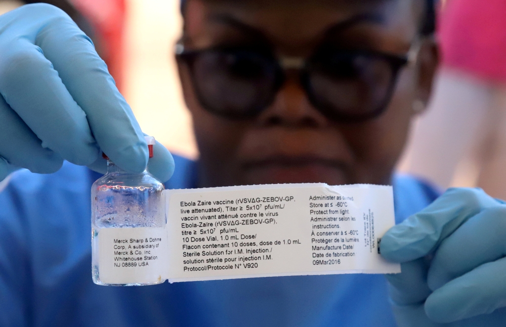 File photo of a World Health Organization (WHO) worker prepares to administer a vaccination during the launch of a campaign aimed at beating an outbreak of Ebola in the port city of Mbandaka, Democratic Republic of Congo May 21, 2018. REUTERS/Kenny Katomb