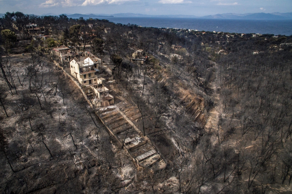  In this file photo taken on July 24, 2018 an aerial view shows damage caused by a wildfire near the village of Mati, near Athens. / AFP / Savvas KARMANIOLAS 