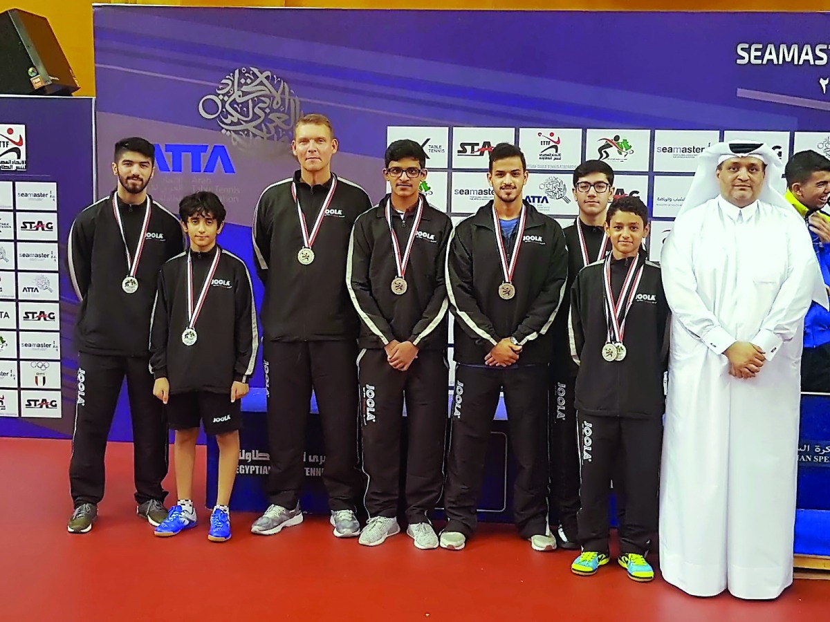Qatar’s table tennis team players and officials pose for a group picture.