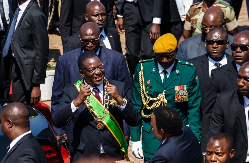 Zimbabwe President Emmerson Mnangagwa (C) gestures during the Heroes Day commemorations held at the National Heroes Acre in Harare August 13, 2018.  AFP / Jekesai Njikizana  