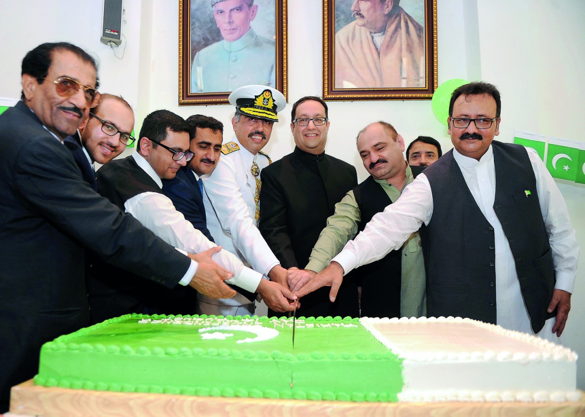 Murad Baseer (centre), Charge d’Affaires at the Embassy of Pakistan, cutting a cake with other officials at the embassy premises yesterday. Pic: Abdul Basit / The Peninsula