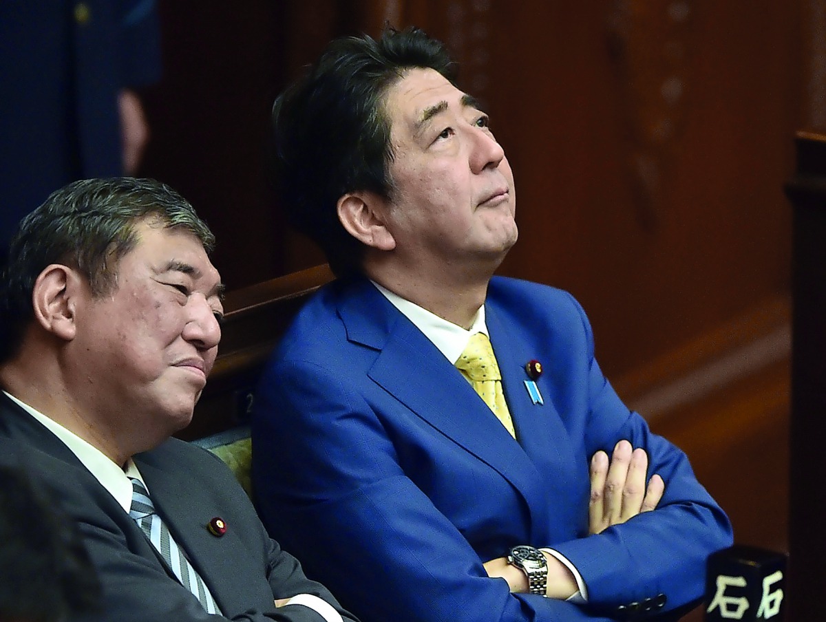 In this file photo taken on July 16, 2015 Japan's Prime Minister Shinzo Abe (R) and then Regional Revitalization Minister Shigeru Ishiba (L) listen to a speech by a member of an opposition party at the parliament in Tokyo.  AFP / Kazuhiro Nogi
 