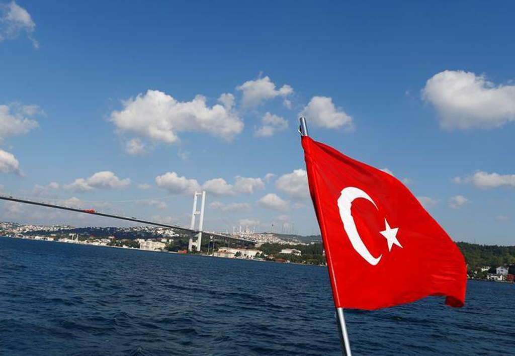 File photo of the Turkish flag is pictured on a boat with the Bosphorus bridge in the background in Istanbul, Turkey, August 6, 2016. REUTERS/Osman Orsal