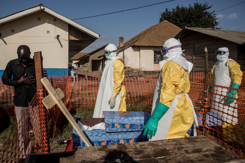 A family member of a deceased, unconfirmed Ebola patient, reacts inside an Ebola Treatment Centre run by The Alliance for International Medical Action (ALIMA) on August 13, 2018, in Beni. AFP / John Wessels 