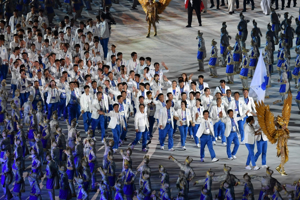 Unified Korea's flagbearer Lim Yung-hui leads the delegation during the opening ceremony of the 2018 Asian Games at the Gelora Bung Karno main stadium in Jakarta on August 18, 2018. / AFP / ADEK BERRY