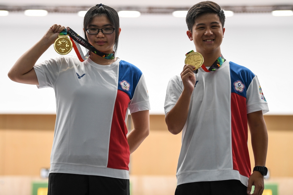 Gold medallists Taiwan's Lin Yingshin (L) and Lu Shaochuan pose with their medals during the victory ceremony for the 10m air rifle mixed team shooting final during the 2018 Asian Games in Palembang on August 19, 2018. / AFP / Mohd RASFAN 