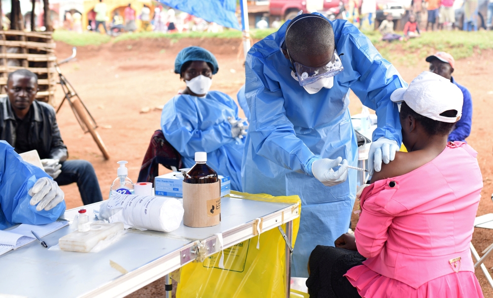 FILE PHOTO: A Congolese health worker administers Ebola vaccine to a woman who had contact with an Ebola sufferer in the village of Mangina in North Kivu province of the Democratic Republic of Congo, August 18, 2018. REUTERS/Olivia Acland