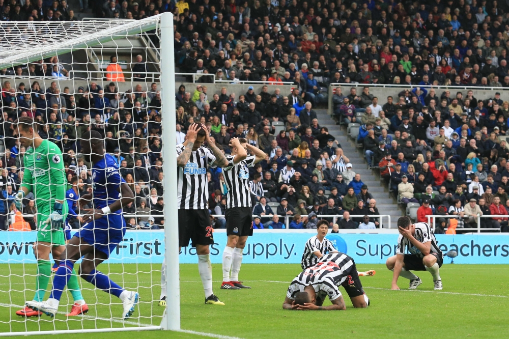 Newcastle players react after Newcastle United's US defender DeAndre Yedlin (2R) scored an own goal for Chelsea's second during the English Premier League football match between Newcastle United and Chelsea at St James' Park in Newcastle-upon-Tyne, north 