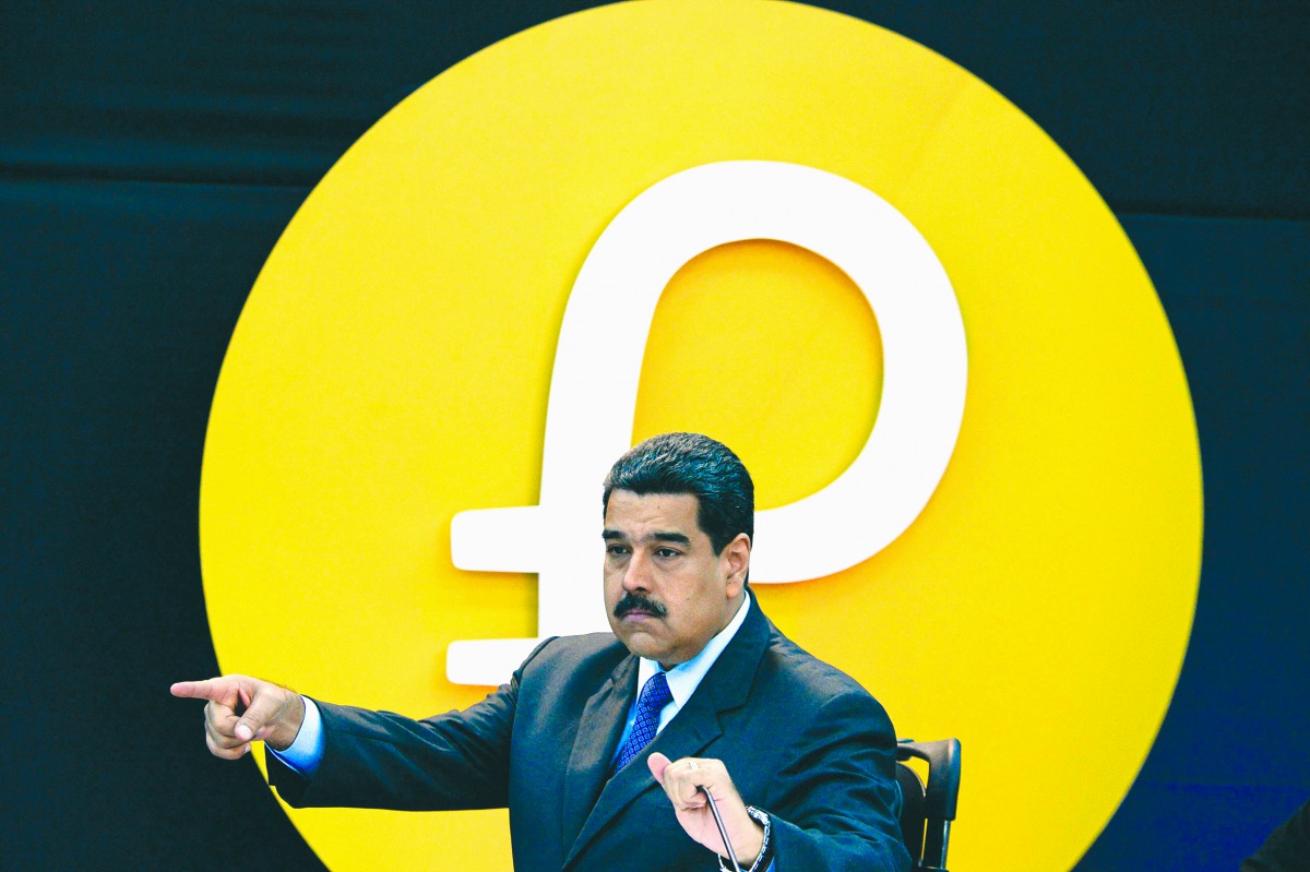 
In this file photo taken on February 20, 2018 Venezuela's President Nicolas Maduro gestures during a press conference to launch to the market a new oil-backed cryptocurrency called 