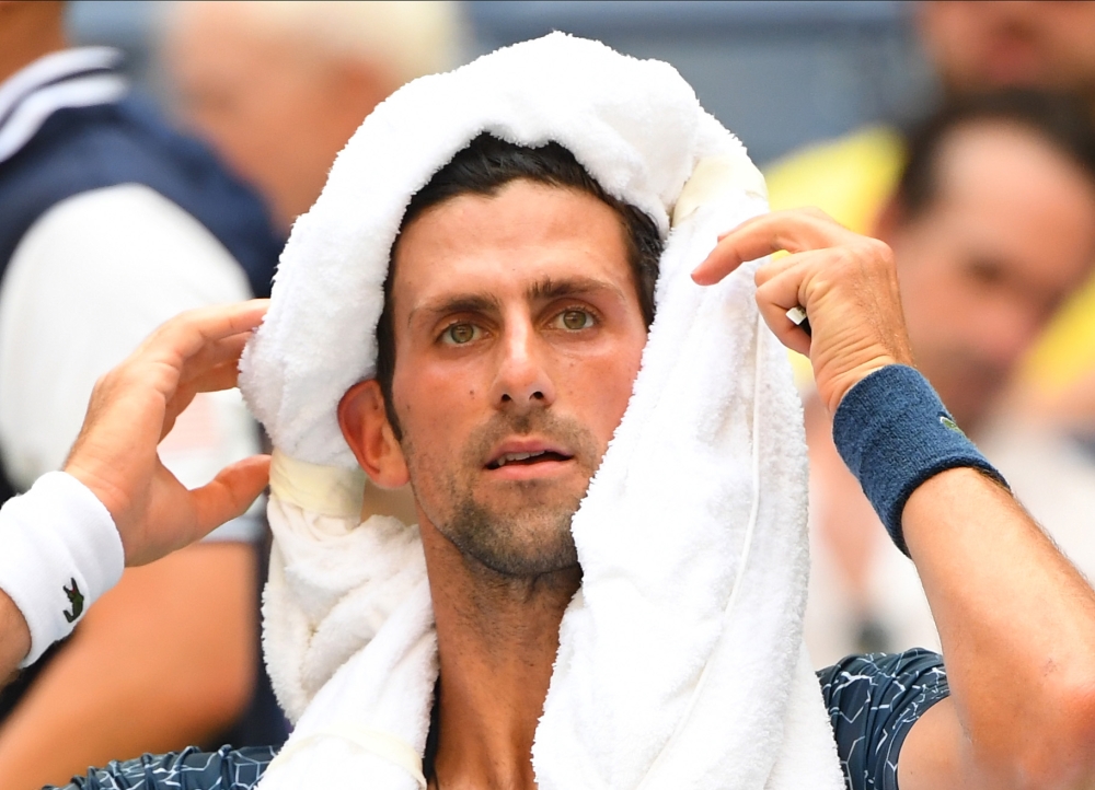  Novak Djokovic of Serbia coping with the extreme heat while playing Marton Fucsovics of Hungary in a first round match on day two of the 2018 Credit: Robert Deutsch-USA TODAY Sports