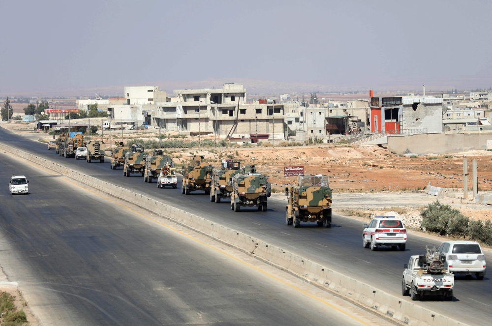 Turkish forces are seen in a convoy on a main highway between Damascus and Aleppo, near the town of Saraqib in the northern Idlib province, on August 29, 2018.   AFP / OMAR HAJ KADOUR
