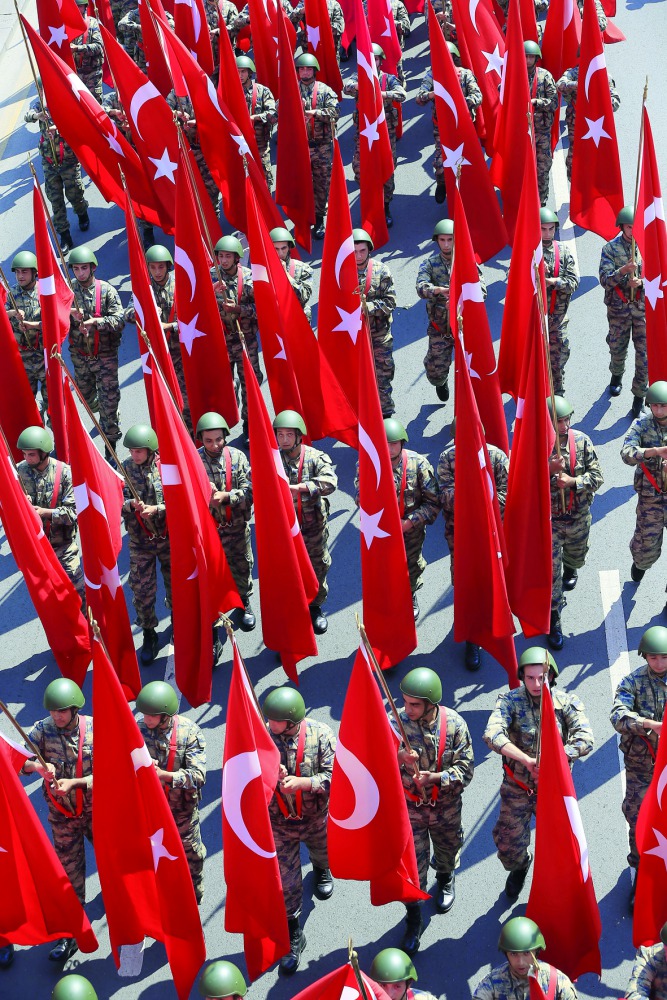 Turkish soldiers take part in a parade from the Grand National Assembly of Turkey (TBMM) to the first Turkish Grand National Assembly building in the Ulus district during celebrations to mark 96th Anniversary of Turkey’s Victory Day which commemorates dec