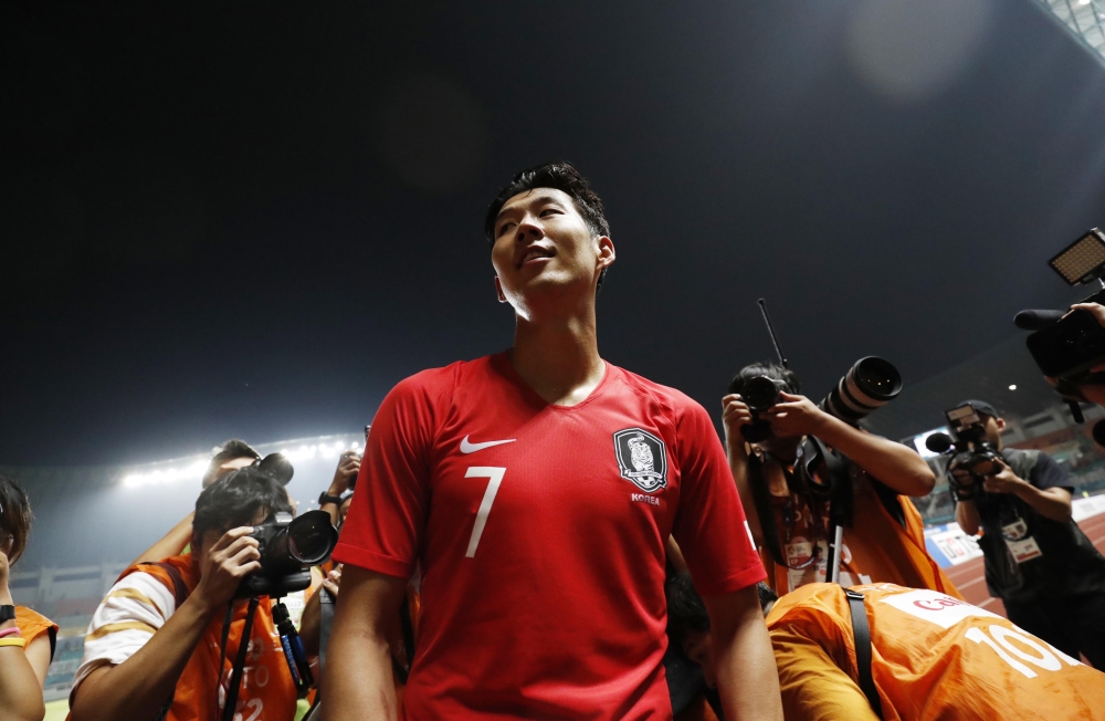 Son Heung Min of South Korea celebrates after winning the gold medal. REUTERS/Darren Whiteside
