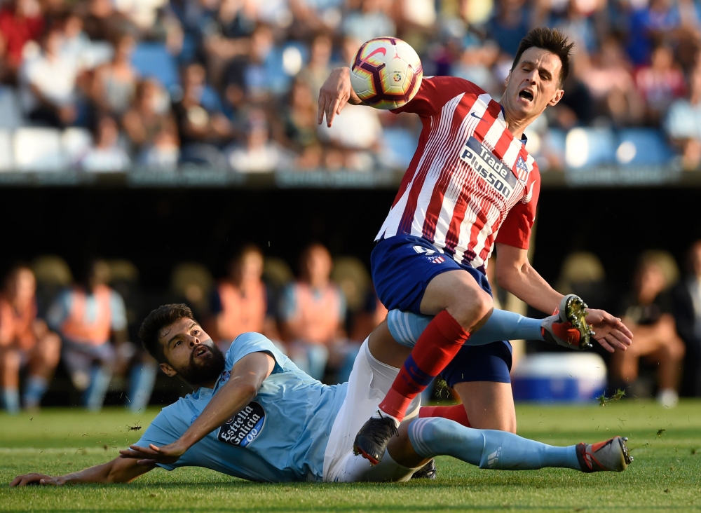 Celta Vigo's Mexican defender Nestor Araujo (L) vies with Atletico Madrid's Croatian forward Nikola Kalinic during the Spanish league football match between RC Celta de Vigo and Club Atletico de Madrid at the Balaidos stadium in Vigo on September 1, 2018.