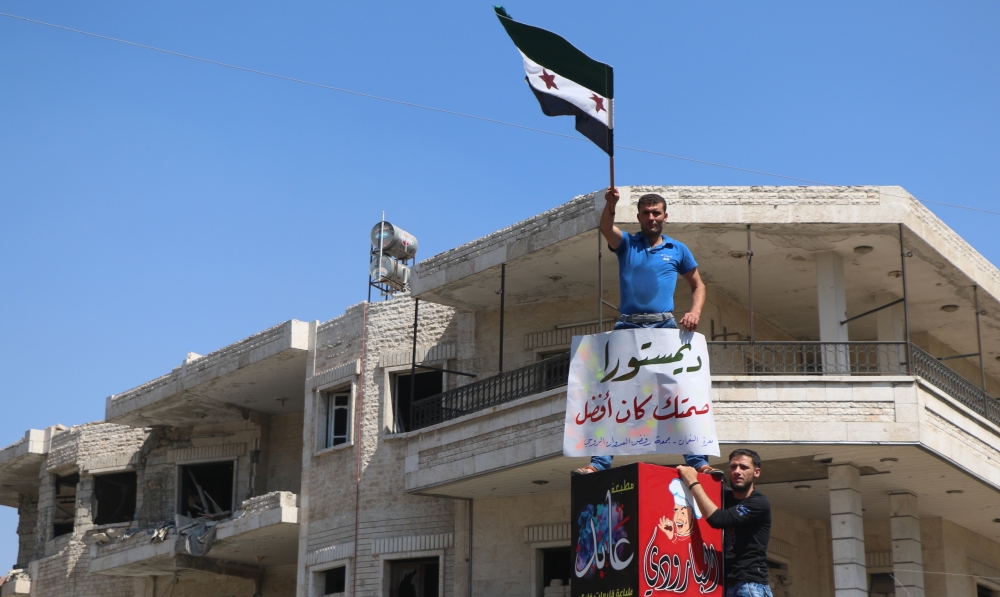 Syrian oppositions demanding Turkey to prevent attacks on Idlib, chant slogans as they protest against regime forces' possible attacks in Syria's Idlib province on August 31, 2018. Ahmet Cerban - Anadolu 