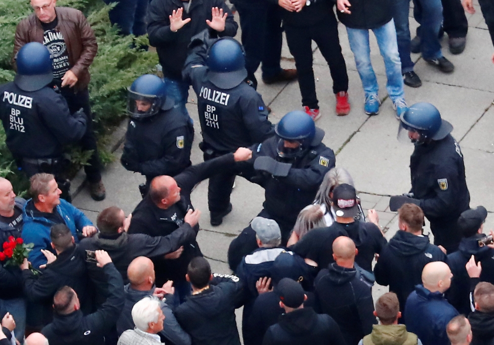 Participants of the demonstration of Germany's anti-immigration party Alternative for Germany (AfD) attack police in Chemnitz, Germany, September 1, 2018. Picture taken September 1, 2018. REUTERS/Hannibal Hanschke