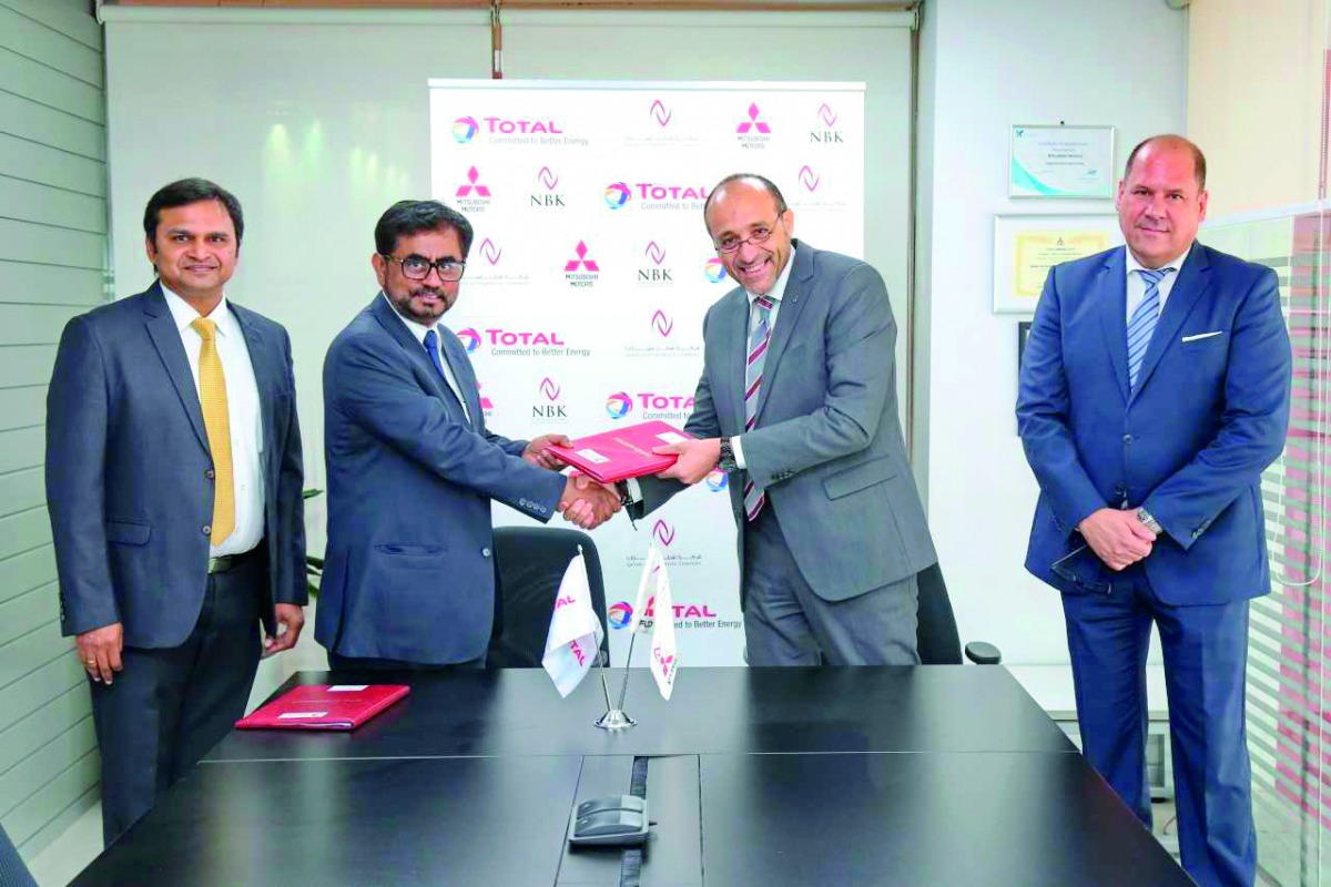TMQ and QAC officials exchanging documents during the renewal of the supply agreement ceremony.
