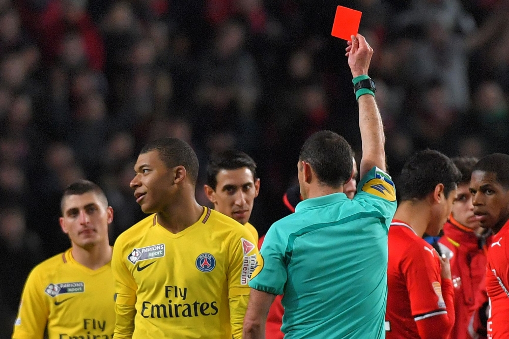 FILE PHOTO: Paris Saint-Germain's French forward Kylian Mbappe (L) reacts as the referee gives him a red card during the French League Cup football semi-final match between Rennes and Paris Saint-Germain at the Roazhon Park stadium in Rennes.  AFP / LOIC 
