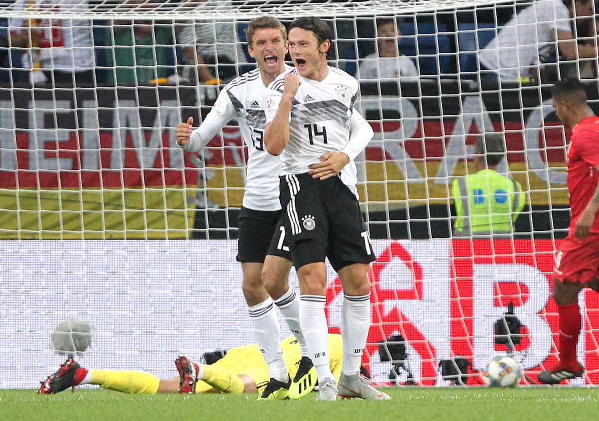 Germany's defender Nico Schulz (R) and Germany's forward Thomas Mueller celebrate scoring during the international friendly football match Germany vs Peru at the Rhein-Neckar-Arena in Sinsheim, southwestern Germany, on September 9, 2018. 