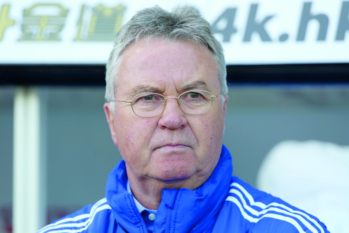 This file picture taken on April 9, 2016 shows then Chelsea's Dutch interim manager Guus Hiddink watching his players warm up ahead of the English Premier League football match between Swansea City and Chelsea at The Liberty Stadium in Swansea, south Wale