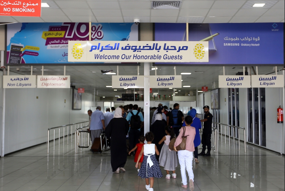 Travellers arrive at the Mitiga International Airport after its reopening on September 7, 2018, in the Libyan capital of Tripoli. / AFP / Mahmud TURKIA