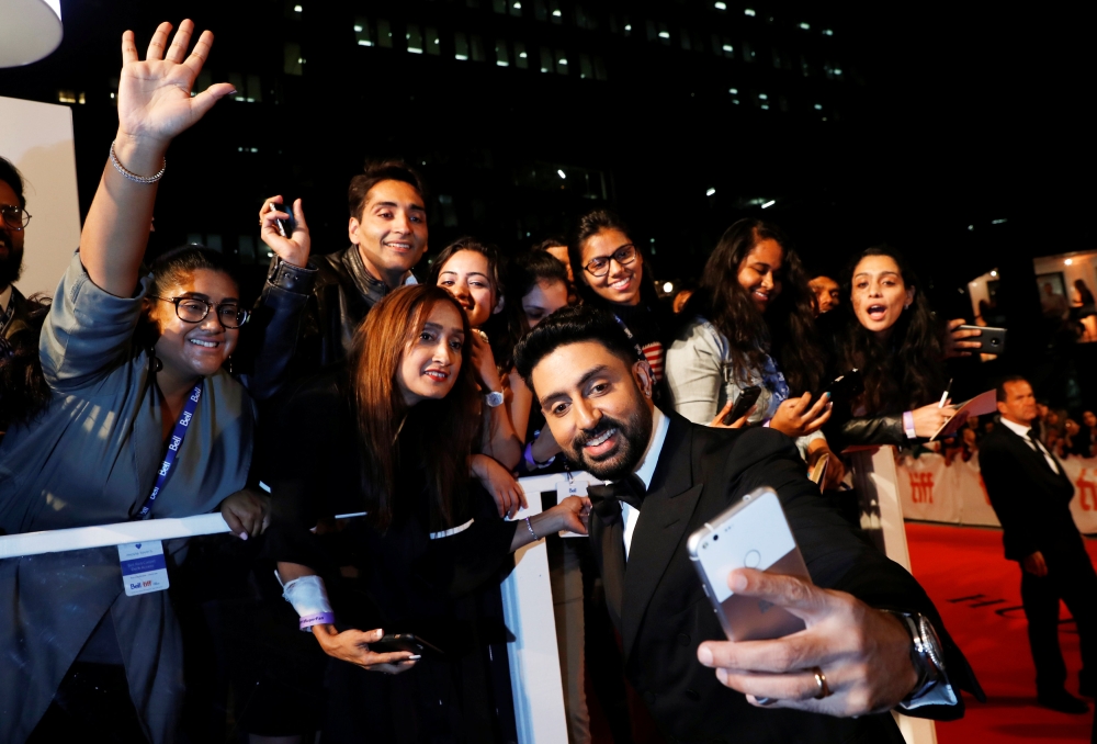 Actor Abhishek Bachchan poses with fans as he arrives for the premiere of Husband Material at the Toronto International Film Festival in Toronto, Ontario, Canada, September 11, 2018. REUTERS/Mark Blinch