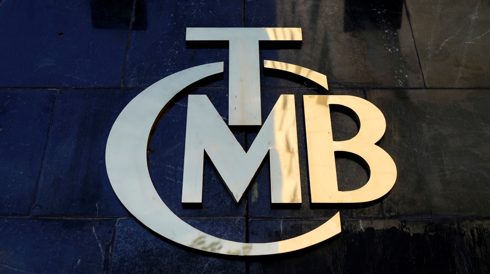 FILE PHOTO: A logo of Turkey's Central Bank (TCMB) is pictured at the entrance of the bank's headquarters in Ankara, Turkey April 19, 2015. REUTERS/Umit Bektas