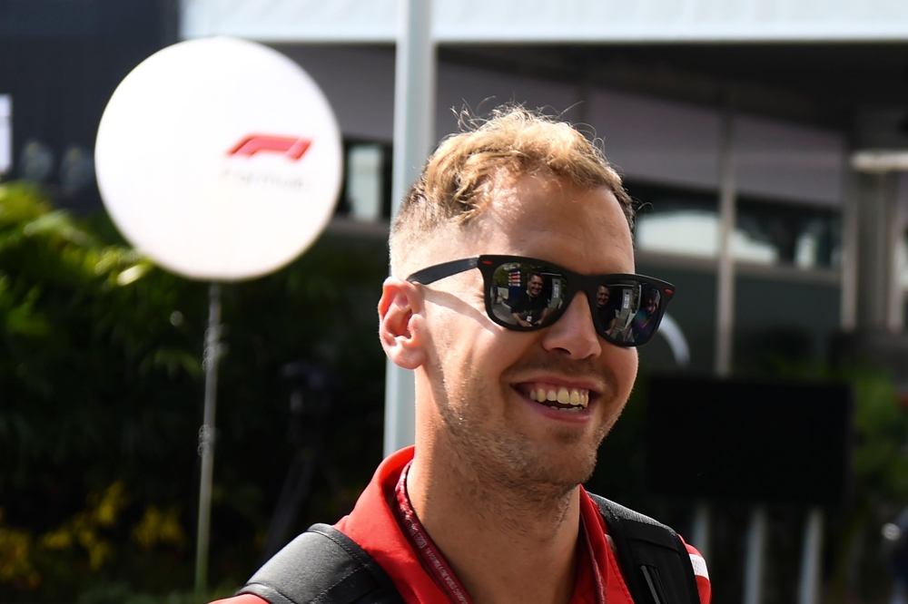 Ferrari's German driver Sebastian Vettel arrives at the Marian Bay Street Circuit in Singapore on September 13, 2018 ahead of the Singapore Formula One Grand Prix. / AFP / Roslan RAHMAN