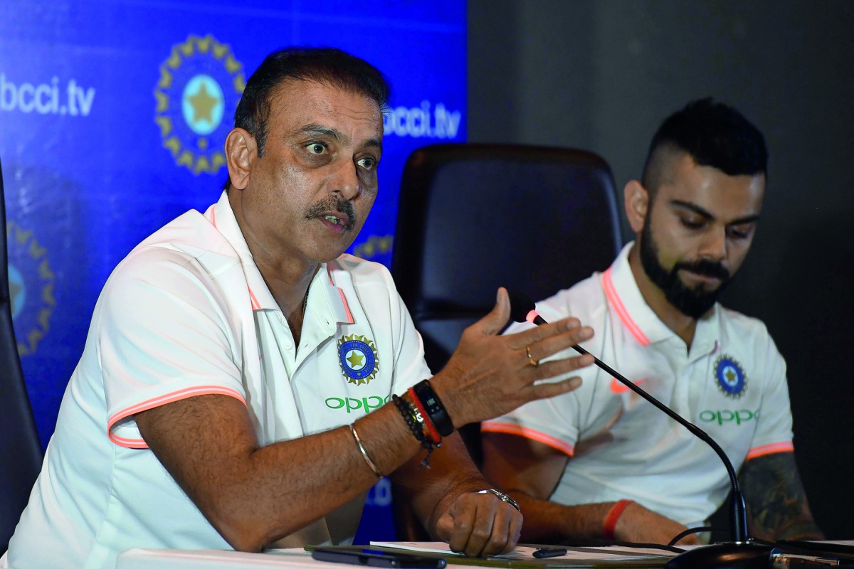 In this file photo taken on June 22, 2018 Indian cricket team head coach Ravi Shastri (L) speaks as captain Virat Kohli looks on during a press conference in New Delhi. Getty/ AFP / Prakash Singh 