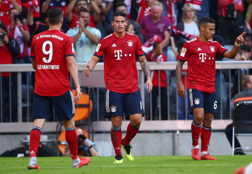 Bayern Munich's James Rodriguez celebrates scoring their third goal with teammates REUTERS/Michael Dalder  
