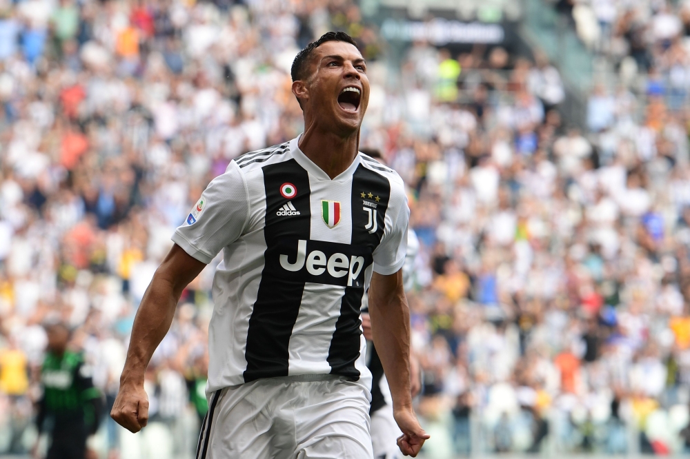 Juventus' Portuguese forward Cristiano Ronaldo celebrates after he scored his first goal since he joined Juventus during the Italian Serie A football match Juventus vs Sassuolo on September 16, 2018 at the Juventus stadium in Turin. / AFP / Miguel MEDINA