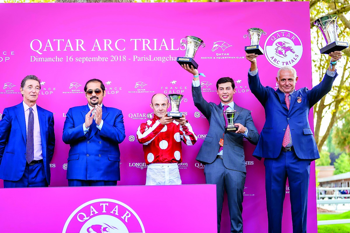 The winning horse in the Qatar Cup – Prix Dragon (Gr1/PA), Yaseed’s jockey Olivier Peslier (centre), trainer Alban de Mieulle, (right) and a team representative celebrate during the presentation ceremony with Qatar Racing and Equestrian Club (QREC) Genera