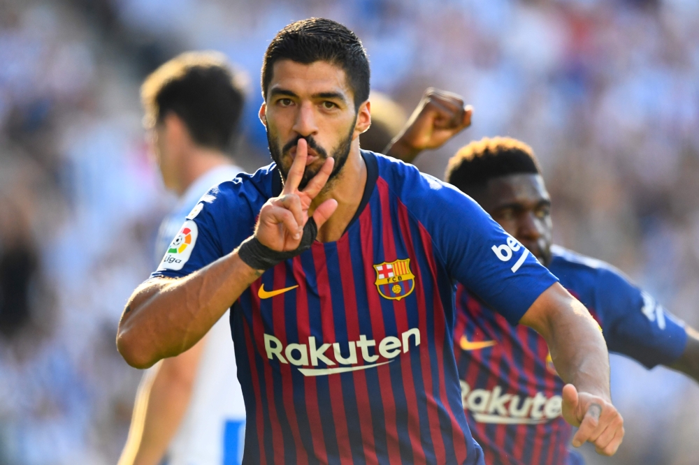 Barcelona's Uruguayan forward Luis Suarez celebrates after scoring a goal during the Spanish league football match between Real Sociedad and FC Barcelona at the Anoeta stadium in San Sebastian on September 15, 2018. / AFP / GABRIEL BOUYS
