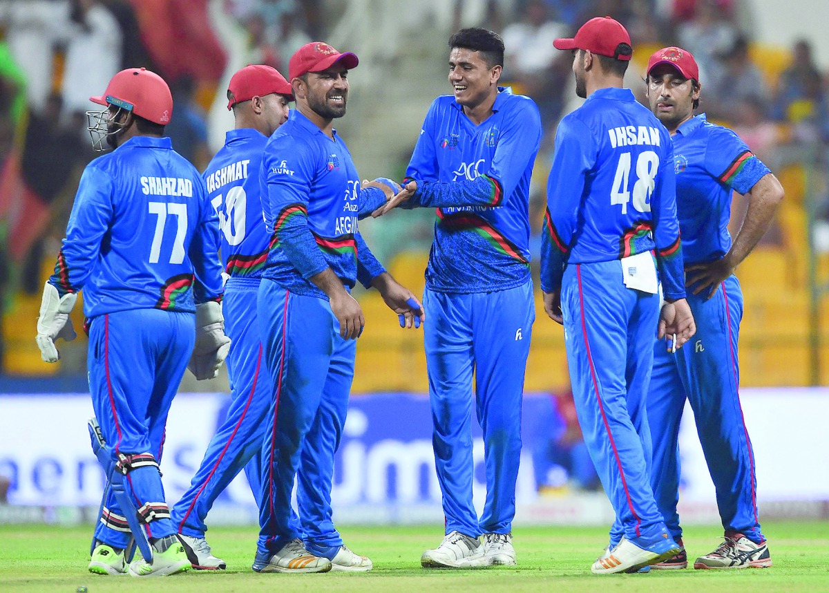 Afghan cricketer Mujeeb Ur Rahman (C) celebrates with his teammates after he dismissed Sri Lankan batsman Dasun Shanaka during the one day international (ODI) Asia Cup cricket match between Sri Lanka and Afghanistan at the Sheikh Zayed Stadium in Abu Dhab