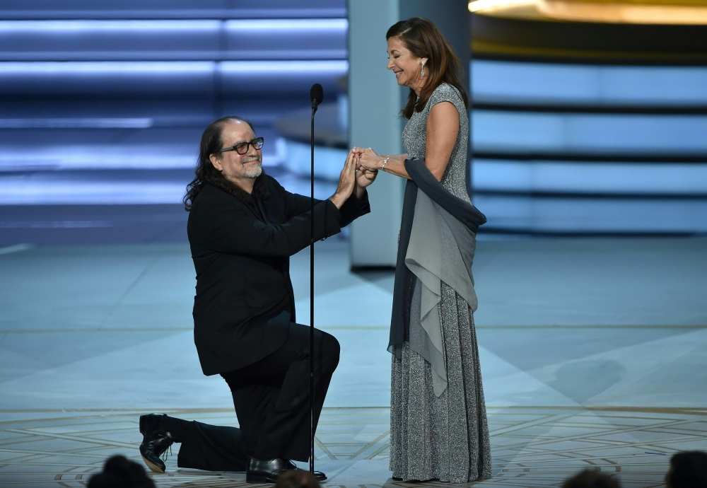 Glenn Weiss (L), winner of the Outstanding Directing for a Variety Special award for 'The Oscars,' proposes marriage to Jan Svendsen onstage during the 70th Emmy Awards at the Microsoft Theatre in Los Angeles, California on September 17, 2018. AFP / Robyn