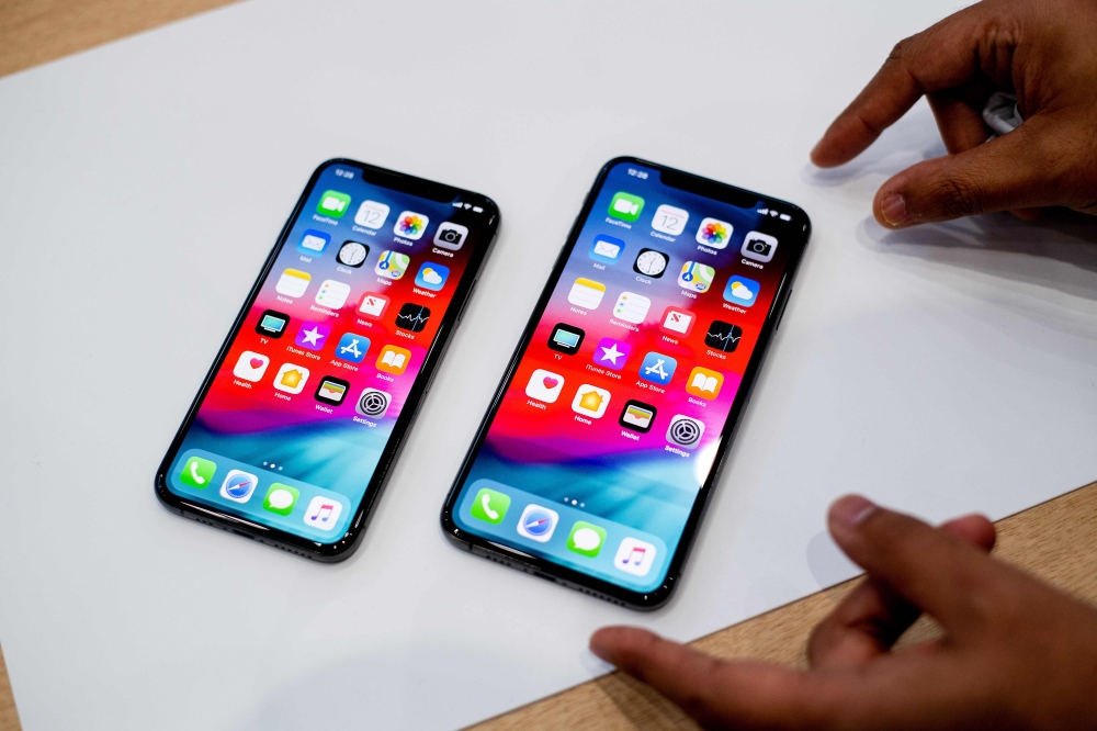 An Apple iPhone Xs Max and iPhone Xs rest on a table during a launch event on September 12, 2018 in Cupertino, California (AFP / Noah Berger) 