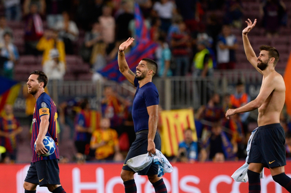 Barcelona's Argentinian forward Lionel Messi, Barcelona's Uruguayan forward Luis Suarez and Barcelona's Spanish defender Gerard Pique leave after the UEFA Champions' League group B football match FC Barcelona against PSV Eindhoven at the Camp Nou stadium 