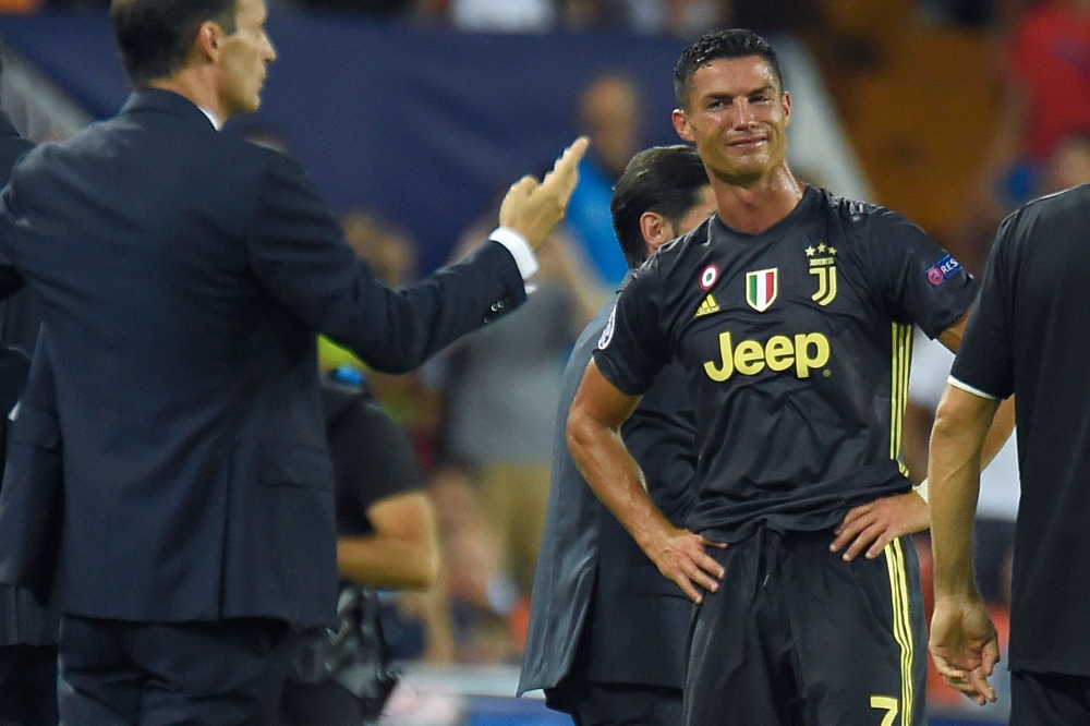 Cristiano Ronaldo reacts after receiving a red card during the group H football match between Valencia CF and Juventus FC at the Mestalla stadium in Valencia on September 19, 2018. / AFP / Jose Jordan 