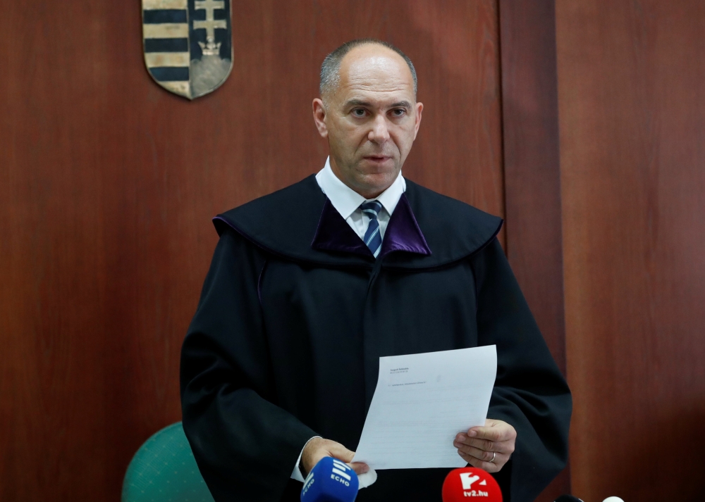 Hungarian judge Erik Mezolaki delivers the verdict in the case of Syrian-Cypriot Ahmed Hamed accused of illegally crossing the border and playing a part in a riot at Hungary's border with Serbia in September 2015, in Szeged, Hungary, September 20, 2018. R