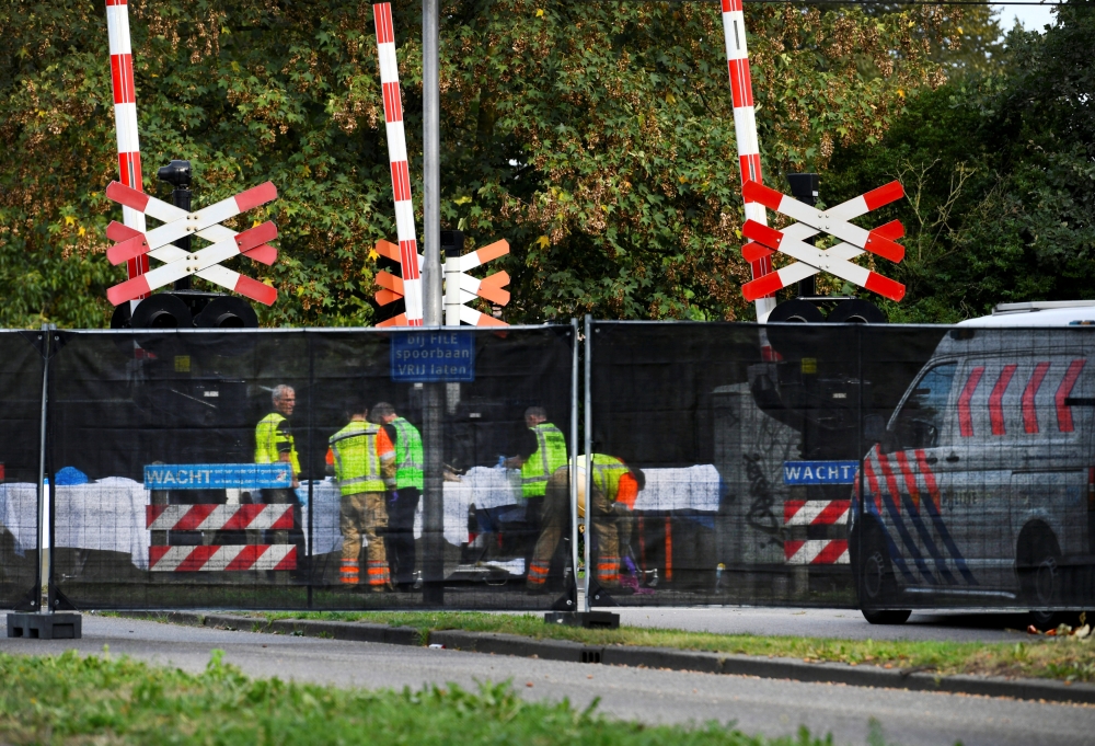 Rescue personnel work at the scene where a train struck a 