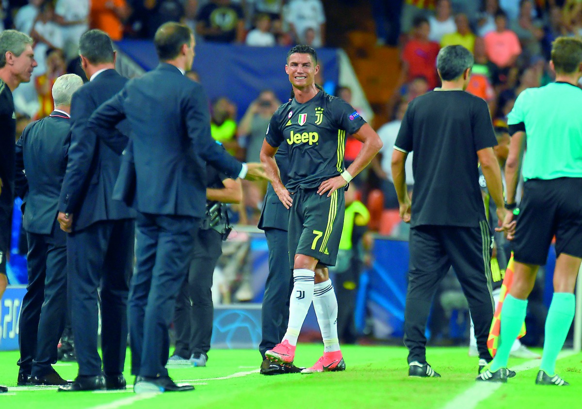 Juventus' Portuguese forward Cristiano Ronaldo (C) cries after receiving a red card during the UEFA Champions League group H football match between Valencia CF and Juventus FC at the Mestalla stadium in Valencia on September 19, 2018.  AFP / Jose Jordan
