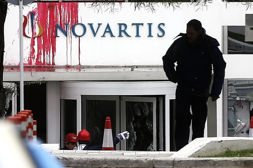 File photo: A view of Novartis building after a group of people from anarchist Ruvikonas conducted a paint attack against the exterior wall of the building on February 25, 2018 in Athens, Greece. (Ayhan Mehmet/Anadolu Agency) 