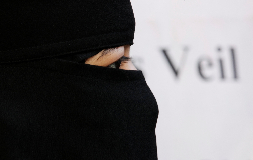 A burqa-wearing Muslim woman takes part in a demonstration outside the French Embassy in London, September 25, 2010. Reuters / Luke MacGregor