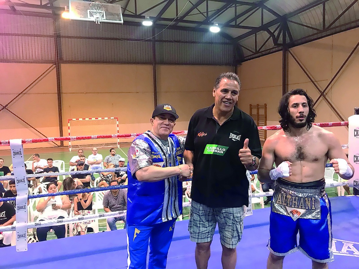 Qatari boxer Fahad Al Thani poses for a picture with his trainers after the Super Welterweight bout in Spain. 
