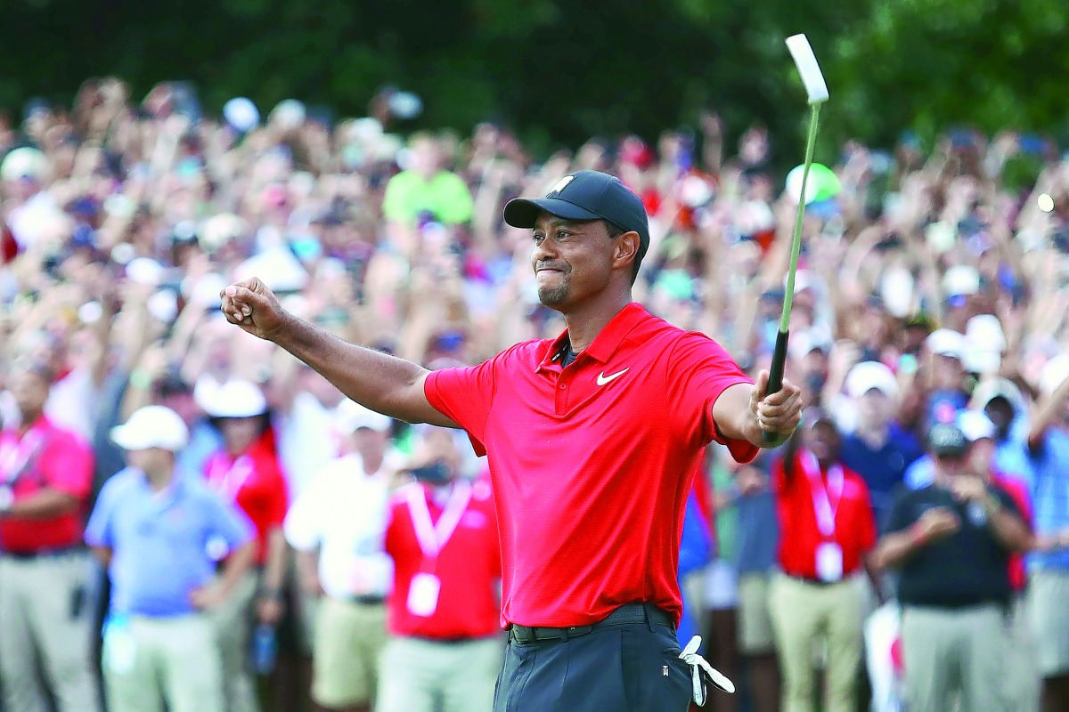 Tiger Woods of the United States celebrates making a par on the 18th green to win the Tour Championship at East Lake Golf Club on September 23, 2018 in Atlanta, Georgia. Tim Bradbury/Getty Images/AFP