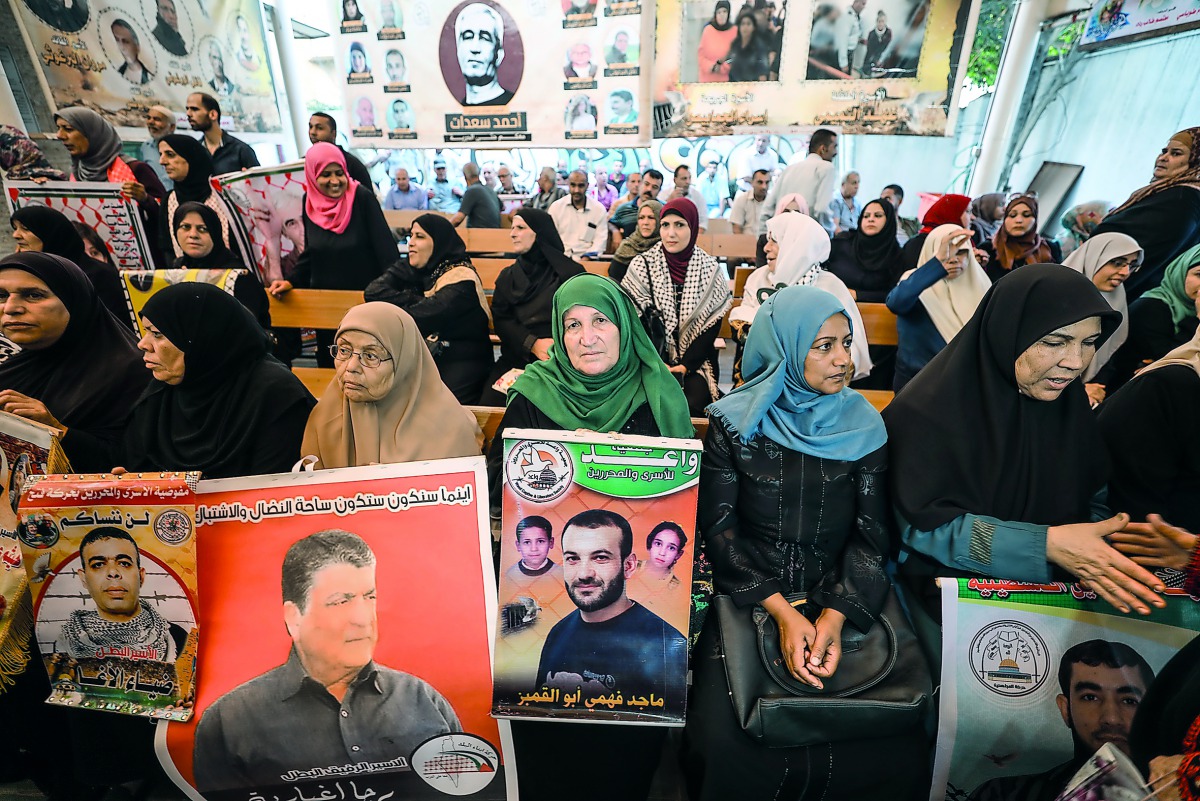 People gather to show their support to the Palestinian prisoners in Israeli jails, in front of International Committee of the Red Cross office in Gaza City, yesterday.